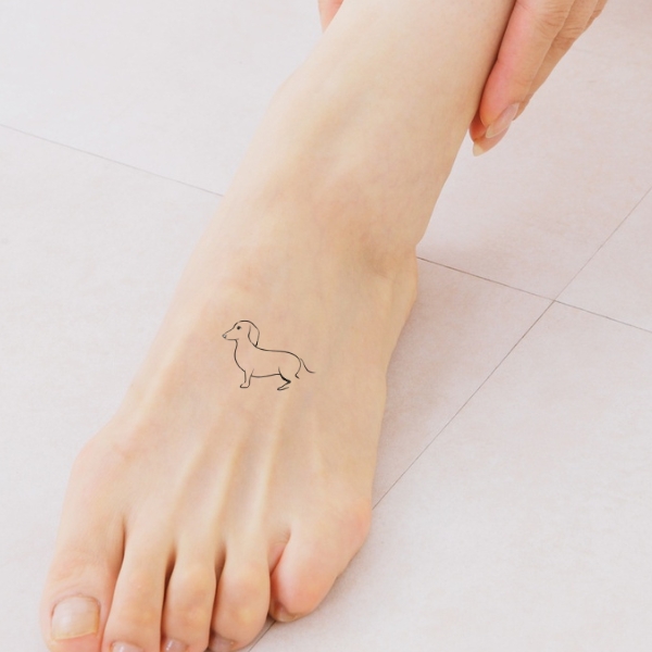 dachshund tattoo on top of foot
