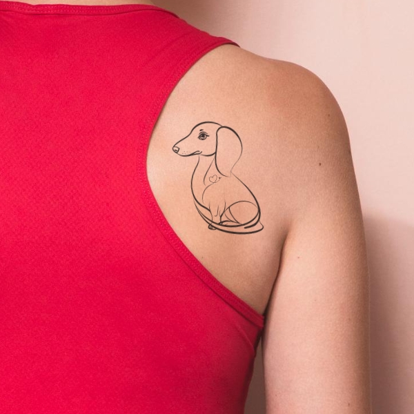 tattoo of dachshund and heart on shoulder